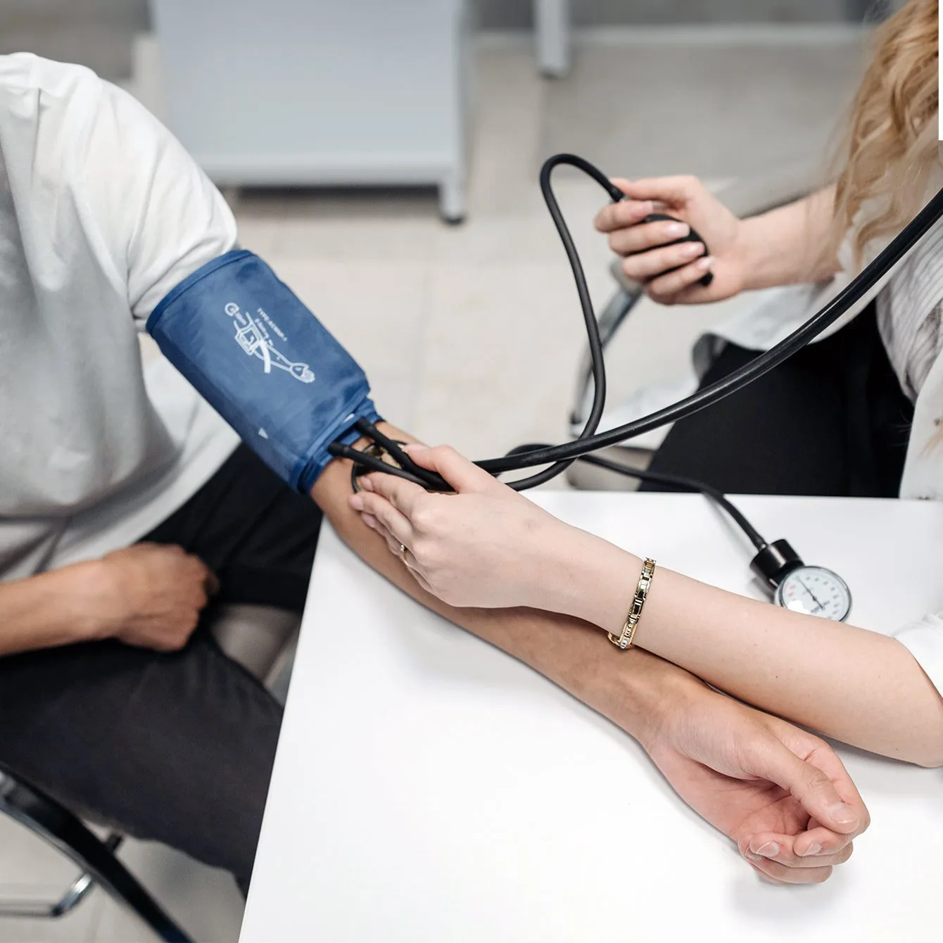 Blood pressure being taken with a cuff on the upper arm